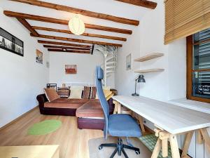a room with a desk with a chair and a couch at Maison de bourg - Charmante & Authentique , PLAUZAT in Plauzat