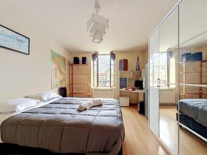 a bedroom with a large bed in a room at Maison de bourg - Charmante & Authentique , PLAUZAT in Plauzat