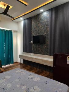 a room with a flat screen tv on a wall at Arista Stay I Studio Room I Sec-4 Greater Noida in Noida