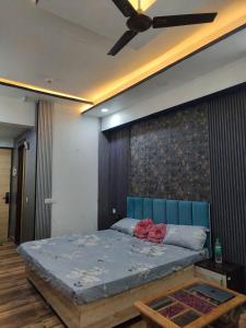 a bedroom with a bed and a ceiling fan at Arista Stay I Studio Room I Sec-4 Greater Noida in Noida