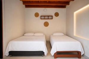 two beds sitting next to each other in a room at Hotel Manglares in Capurganá +17 photos