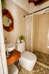 a bathroom with a toilet and a sink at Hotel Manglares in Capurganá