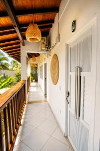 an external walkway leading to a porch with a door at Hotel Manglares in Capurganá
