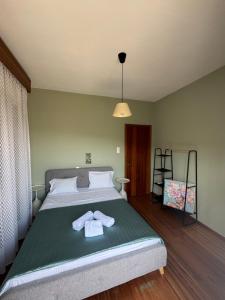 a bedroom with a bed with a robe on it at Metani Residence in Skala Sotiros