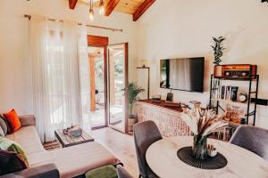 a living room with a table and a tv at Museum Draginë-Guest House in Sukobin