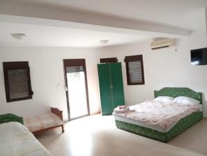 a bedroom with a bed and a couch in it at Kolovic Susanj in Bar