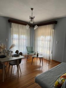 a living room with a bed and a table and chairs at Metani Residence in Skala Sotiros