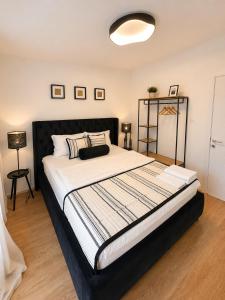 a bedroom with a large bed with a black headboard at Casa Matthias in Kavadarci +34 photos