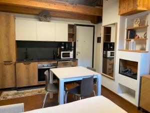 a kitchen with a table and chairs in a room at Maison Poluc - Le Petit Chalet in Champoluc