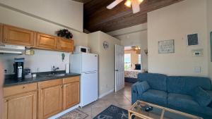 a kitchen with a blue couch and a refrigerator at Manatee Bay Inn in Fort Myers Beach
