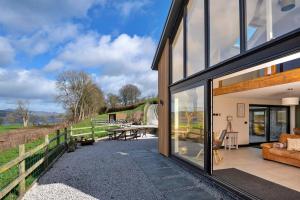 a glass extension to a house with a patio at Finest Retreats - Cae Rhug in Llanuwchllyn