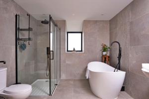 a bathroom with a tub and a toilet and a shower at Finest Retreats - Cae Rhug in Llanuwchllyn +33 photos