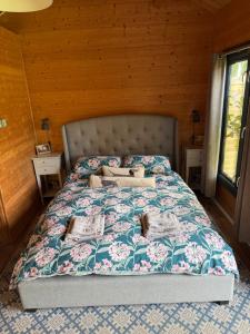 a bedroom with a large bed in a wooden room at Modern Summerhouse in Lymington