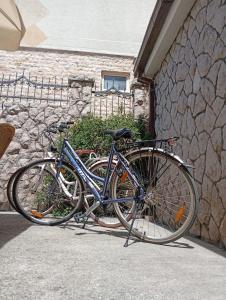 a blue bike parked next to a stone wall at Kolovic Susanj in Bar