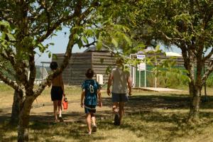 a group of three men walking through a park at Insolite hobbit in Saint-André-dʼAllas