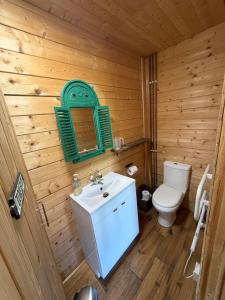 a wooden bathroom with a toilet and a sink at Modern Summerhouse in Lymington +15 photos