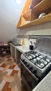 a kitchen with a stove top oven in a kitchen at Mayupata home in Cusco +17 photos