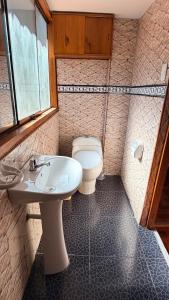 a bathroom with a toilet and a sink at Mayupata home in Cusco