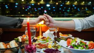 two people holding hands over a table of food at Bosphorus Tour Organization in Istanbul +8 photos