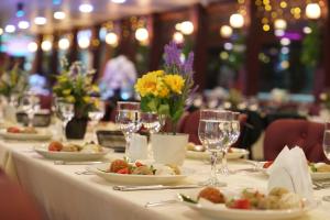 a table with plates of food and wine glasses at Bosphorus Tour Organization in Istanbul