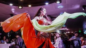 a woman in a dress is dancing in a crowd at Bosphorus Tour Organization in Istanbul