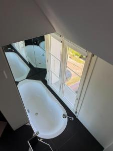 a white toilet in a room with a window at LaVida Panorama Thunersee, Wellness Oasis, Mountains in Thun +17 photos