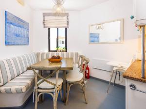 a living room with a couch and a table and chairs at Villa Sunshine in Vale do Lobo +9 photos