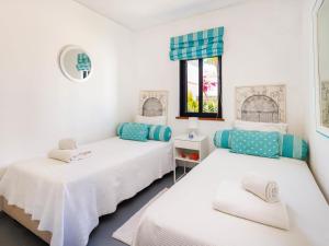 a bedroom with two beds and a window at Villa Sunshine in Vale do Lobo