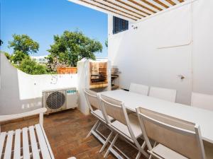 a balcony with a table and chairs and a heater at Villa Sunshine in Vale do Lobo