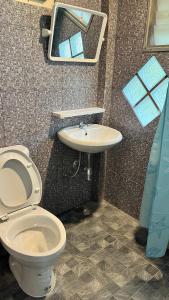 a bathroom with a toilet and a sink at ริมแควโฮมสเตย์ กาญจนบุรี in Ban Pong Pat +45 photos