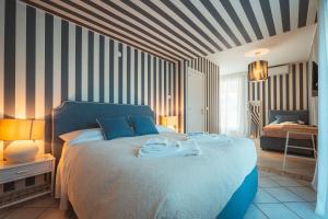 a bedroom with a bed with towels on it at MareLuxe & Pool - Villa By The Sea in Polignano a Mare +52 photos