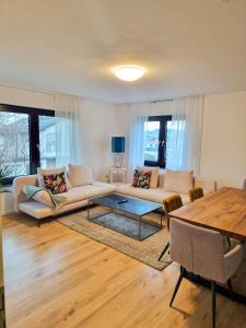 a living room with a couch and a table at ARGENTA Living 42 in Künzell