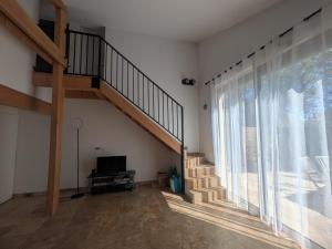 a living room with a staircase and a large window at Maison moderne et lumineuse in Cavaillon
