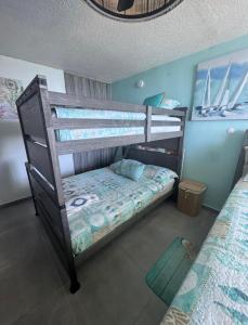 a bedroom with two bunk beds in a room at Private Island Oceanview Condo in Fajardo +33 photos