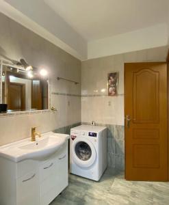a bathroom with a washing machine and a sink at Family Home in Amarynthos +43 photos