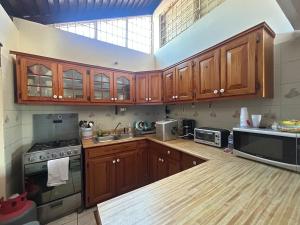 a kitchen with wooden cabinets and a large window at Luxury Oasis Villa in Silver Sands