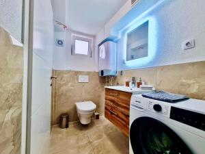 a bathroom with a washing machine and a toilet at Mini Lea in Jadranovo +12 photos