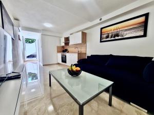 a living room with a blue couch and a table at Mini Lea in Jadranovo