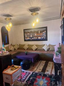 a living room with a couch and a table at Dar Nomads in Chefchaouen