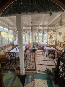 a large room with tables and couches in it at Dar Nomads in Chefchaouen