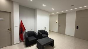 a waiting room with two chairs and a table at Eden Rooms in Vlorë