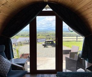 an open door to a patio with a picnic table at Kingsford Pod in Wexford +4 photos