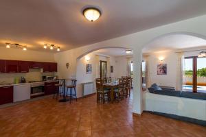 a kitchen and living room with a couch and a table at Villa Antonela in Divšići