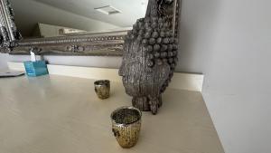 a group of vases sitting on a table in a room at Gorse Lodge Lakeside & Courtyard in Stubton