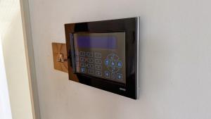 a microwave hanging on a wall at Gorse Lodge Lakeside & Courtyard in Stubton
