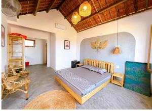 a bedroom with a bed and a ladder and a chair at Blue Sea Homestay 2 in Phu Yen