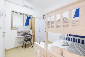 a bedroom with a bunk bed and a desk at Masada34a City Center in Haifa