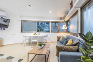 a living room with a couch and a table at Masada34a City Center in Haifa