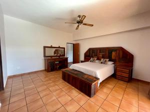 a bedroom with a bed and a ceiling fan at Emmanuel Guest Villa in Thabazimbi