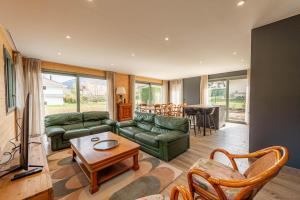 a living room with a couch and a table at Villa Mareyland Saint-Jorioz, in Saint-Jorioz